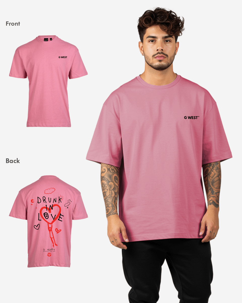Lifestyle shot of the pink oversized t-shirt showcasing heart graphic and text design.