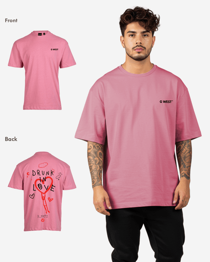 Lifestyle shot of the pink oversized t-shirt showcasing heart graphic and text design.