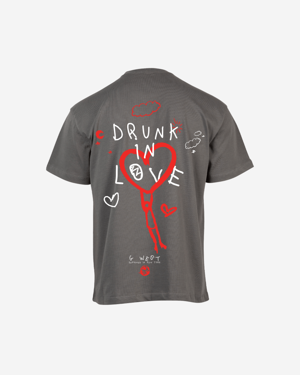 Lifestyle shot of the pink oversized t-shirt featuring heart graphic and text design.