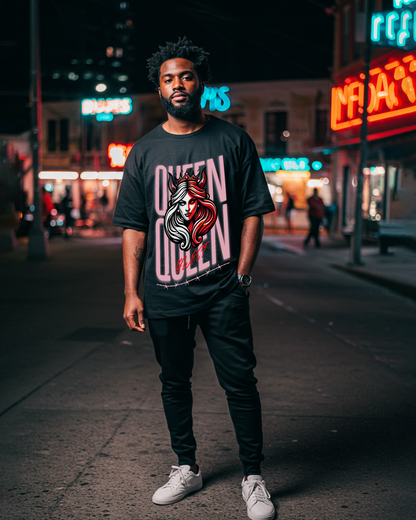 Black oversized t-shirt featuring graphic print in a lifestyle view on a natural background.