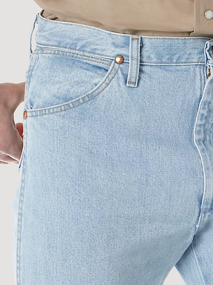 Detail of the front pocket showcasing a gold button and slim fit.