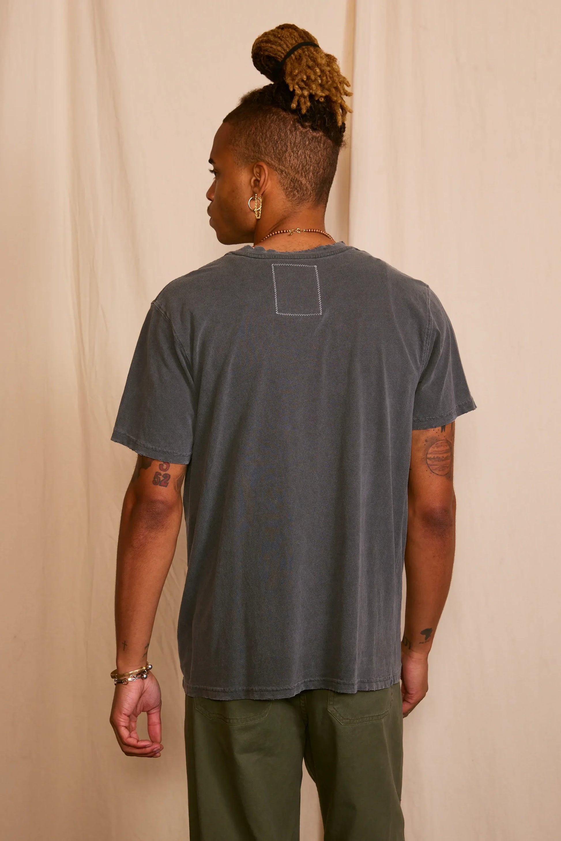 Back view of the gray graphic t-shirt with short sleeves.