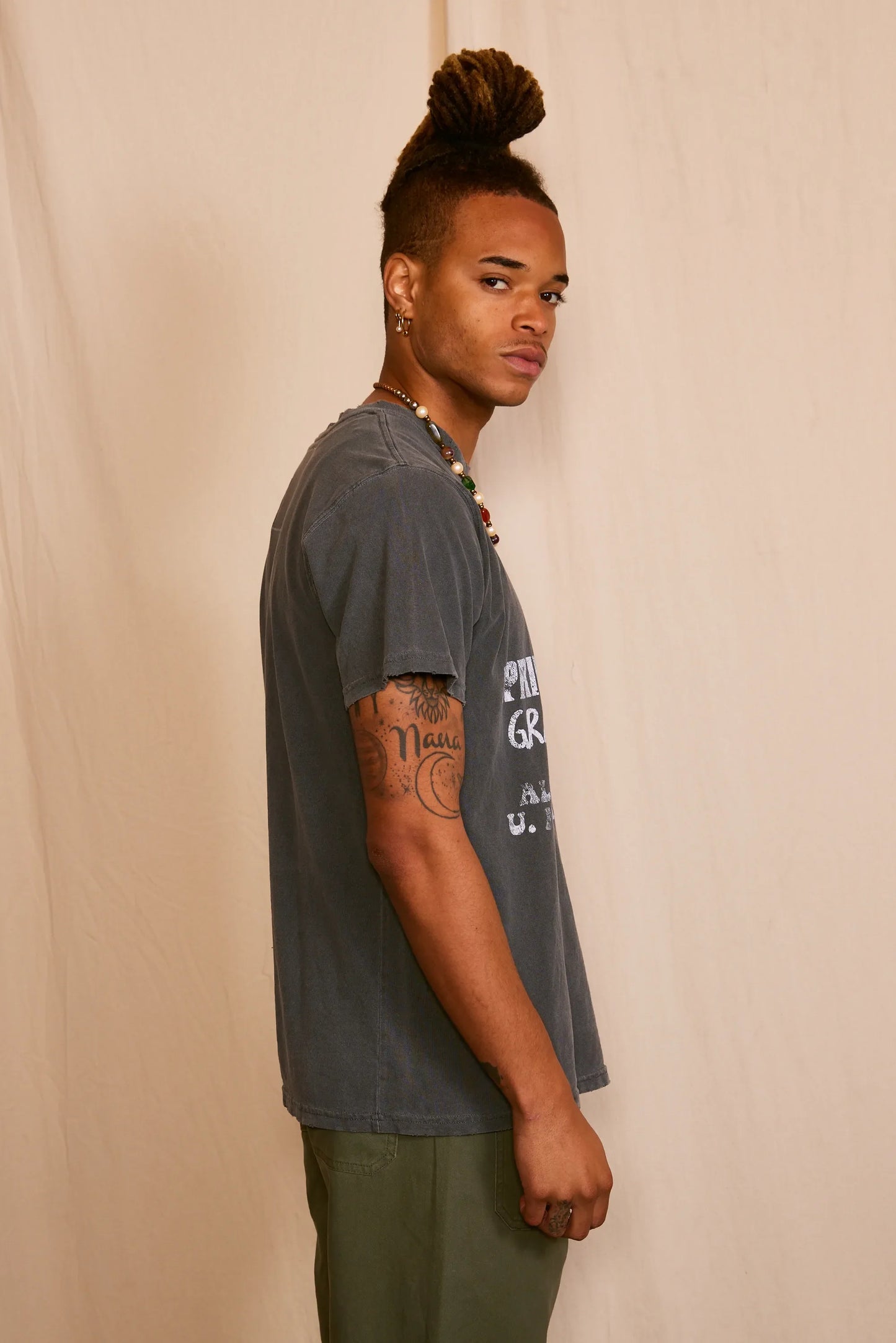 Side view of the gray graphic t-shirt showcasing short sleeves.
