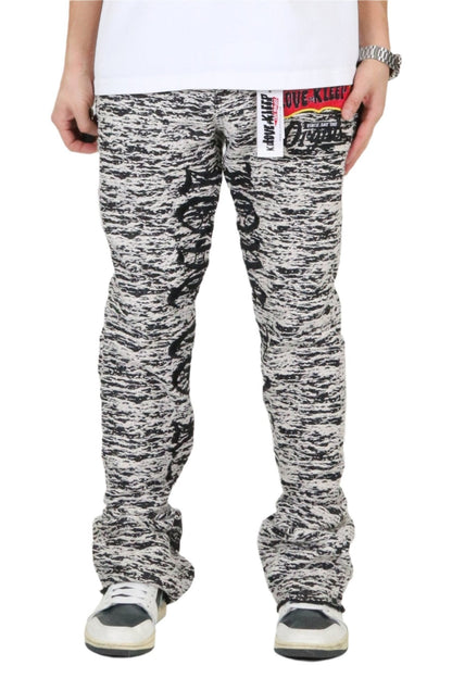 Front view of the black and white jacquard pattern stack fit denim pants.