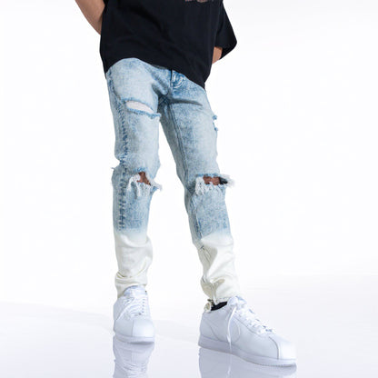 Front view of a man in blue ripped jeans showcasing casual style.