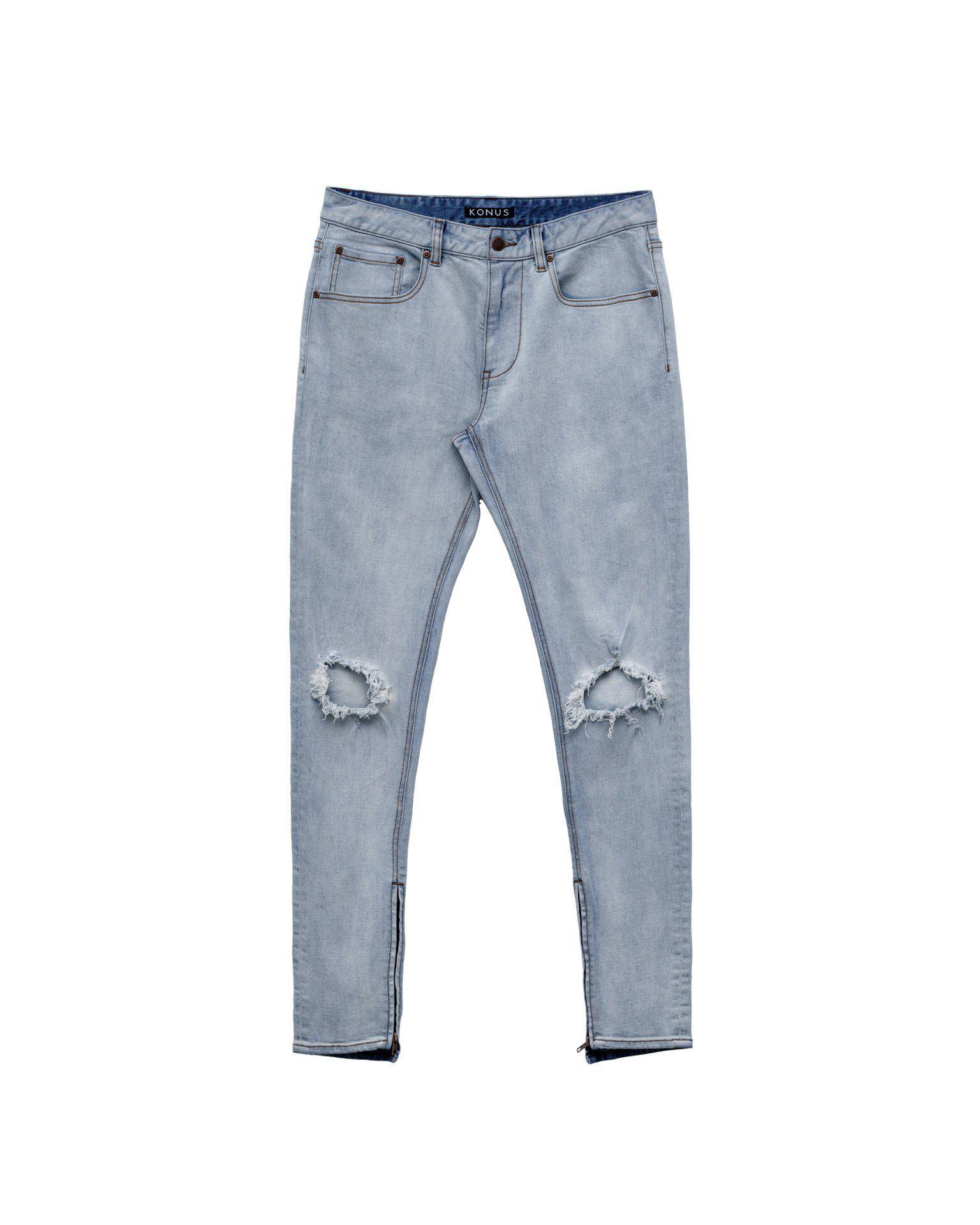 Front view of light blue jeans with ripped knees on a white background