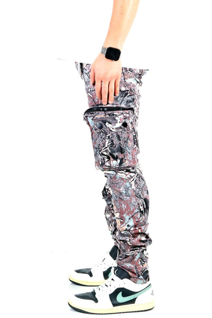 Side view of the forest camo cargo pants with a hand on the fabric.