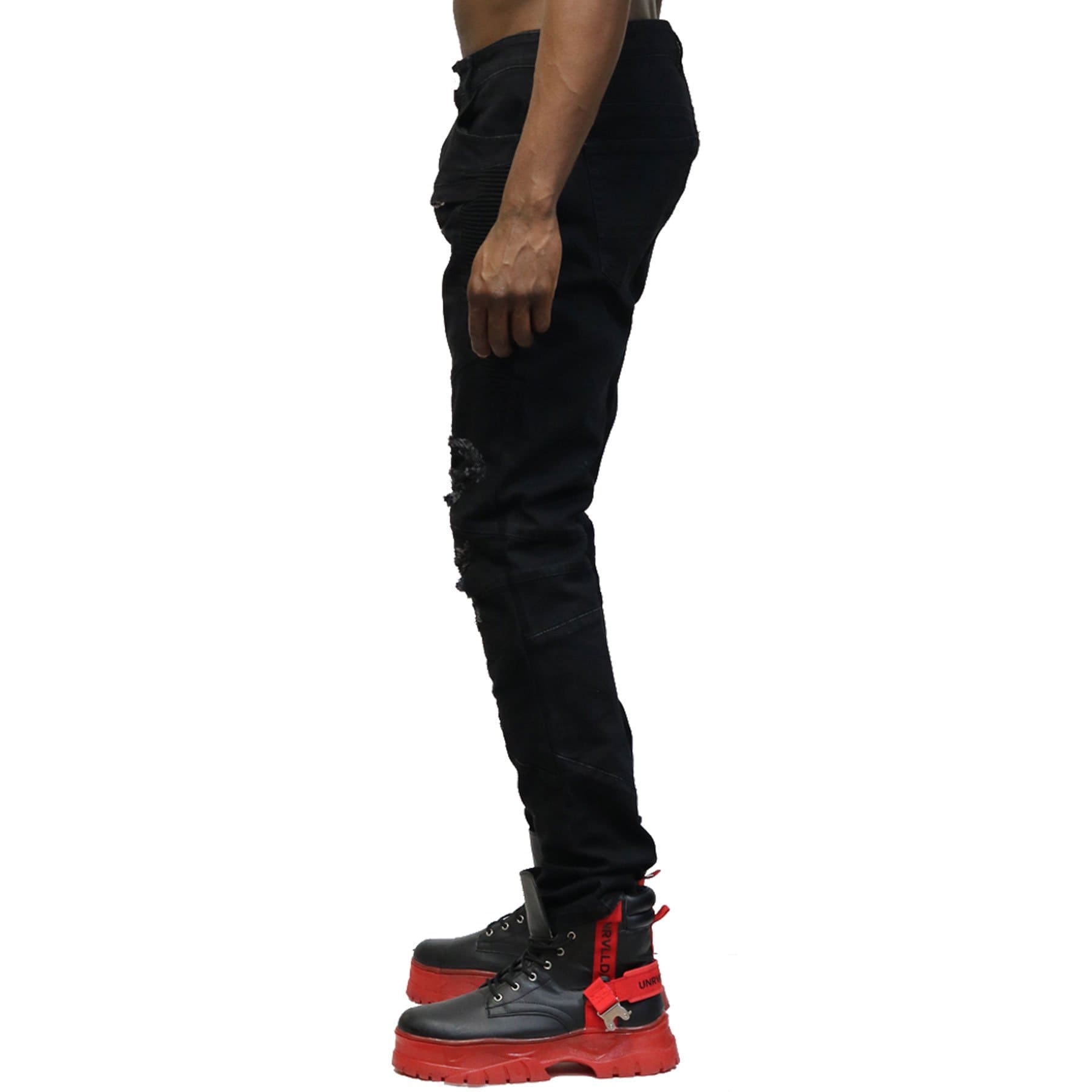 Back view of the black denim pants with rip-off details.