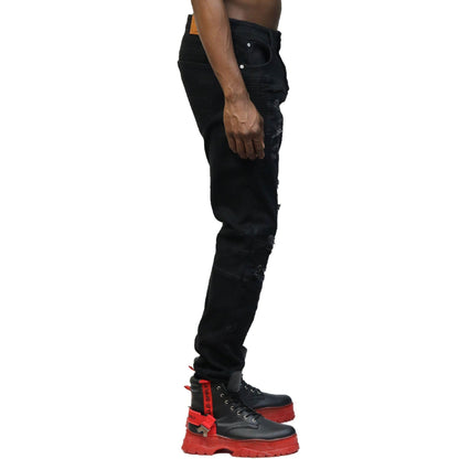 Side view of the black denim pants showcasing the skinny fit.