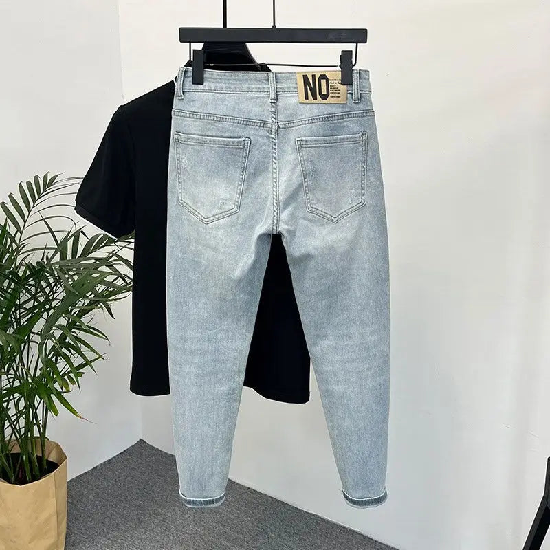 Back view of light blue skinny jeans with a tag on the waistband.