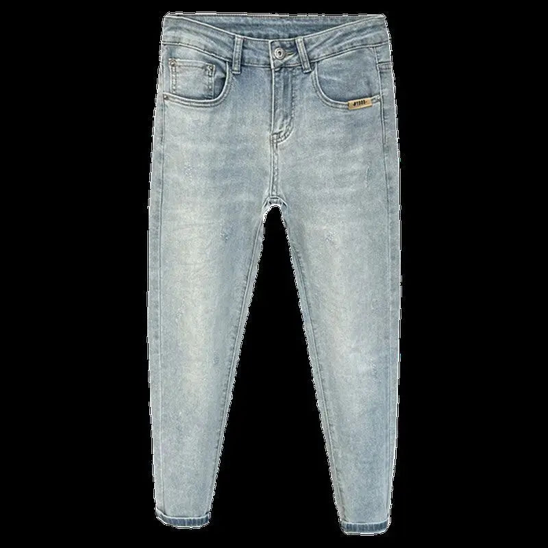 Front view of light blue skinny jeans with distressed details and five pockets.