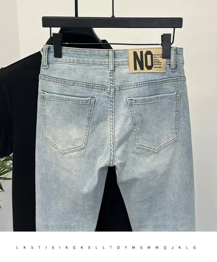 Back view of light blue skinny jeans showing back pockets and brand tag.