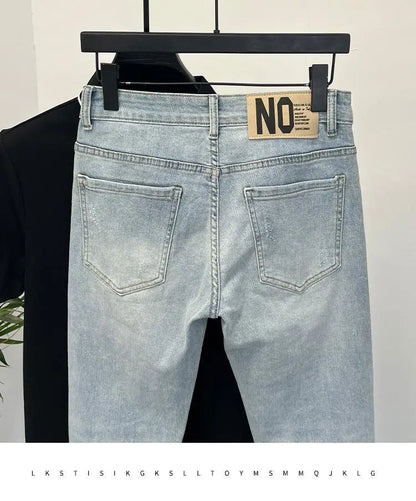 Back view of light blue skinny jeans showing back pockets and brand tag.