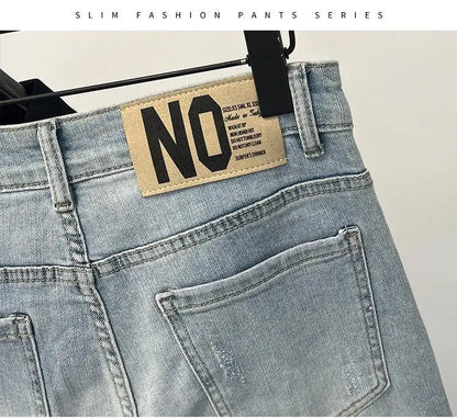 Detail of light blue jeans with distressed details and back label.