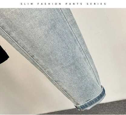 Detail of light blue jeans featuring a faded design and distressed details.