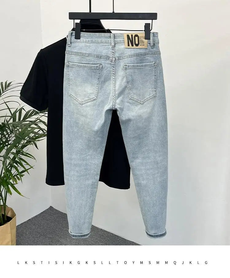 Side view of light blue skinny jeans with a faded design.