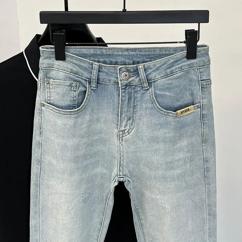 Side view of light blue skinny jeans featuring distressed details.