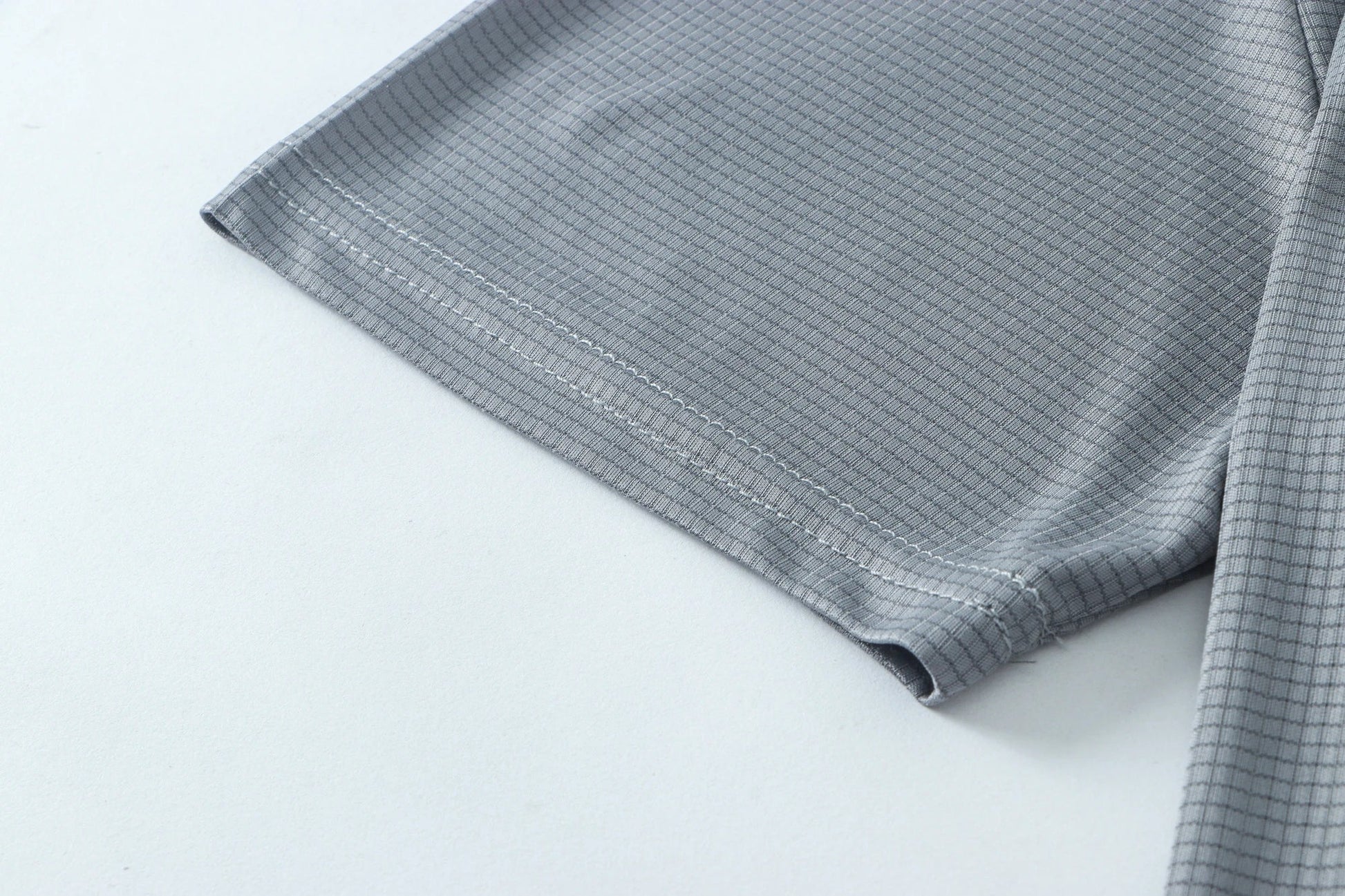 Close-up detail of smooth gray fabric with seam detail.