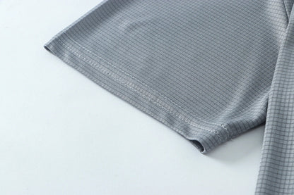 Close-up detail of smooth gray fabric with seam detail.