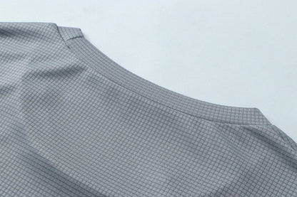Detail shot of gray fabric with smooth finish and curved edge.