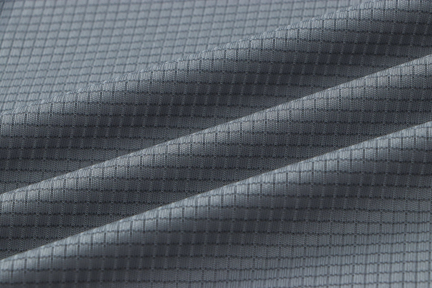 Detail of gray fabric with a smooth texture.