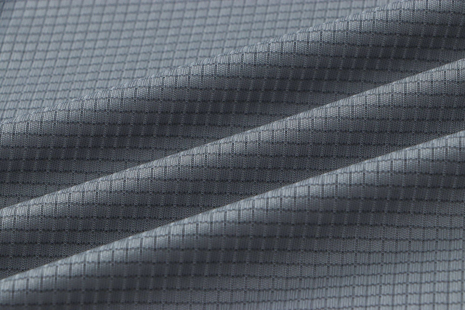 Detail of gray fabric with a smooth texture.