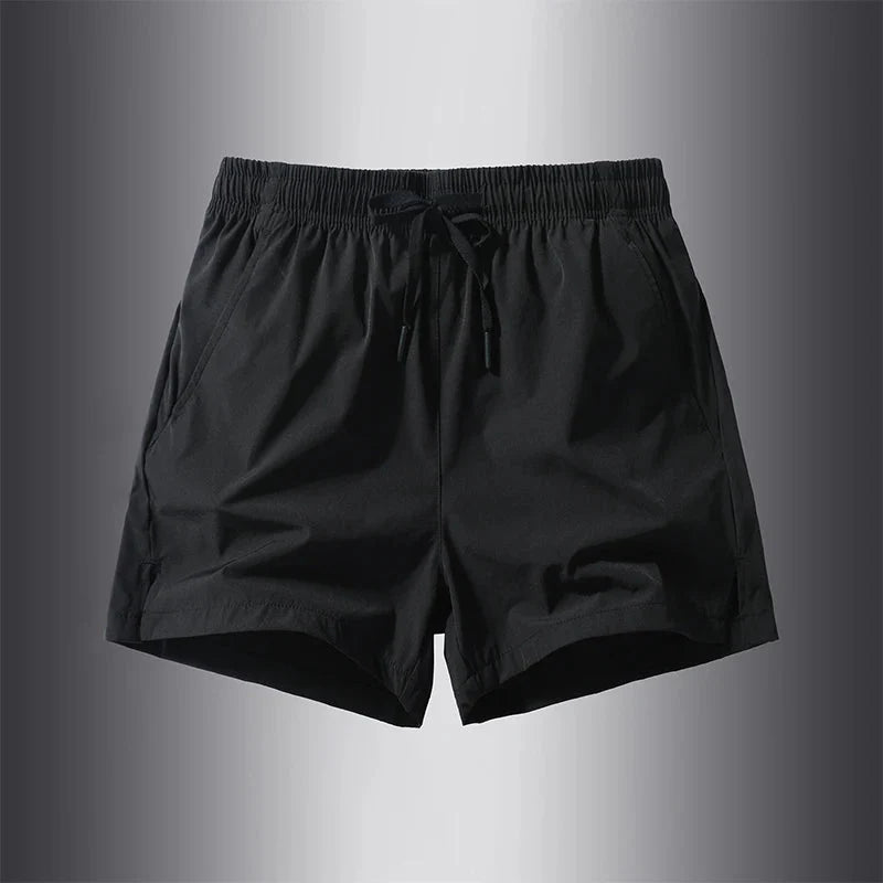 Front view of black running shorts featuring an elastic waistband.