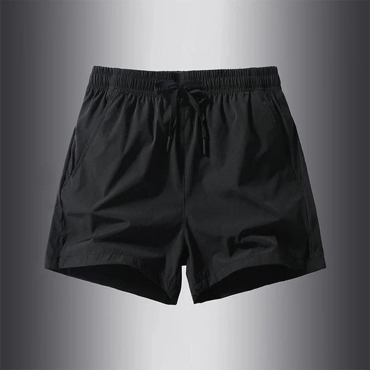 Front view of black running shorts featuring an elastic waistband.