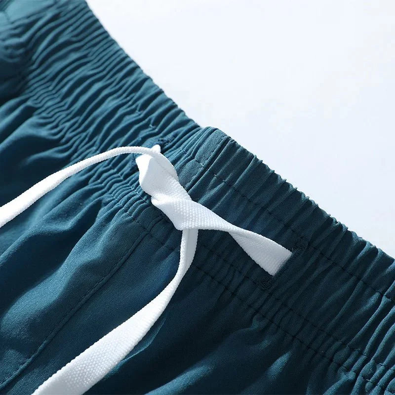 Close-up detail of smooth fabric texture in blue running shorts.