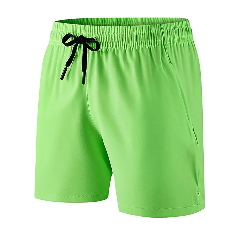 Front view of green running shorts with elastic waistband and drawstring closure.