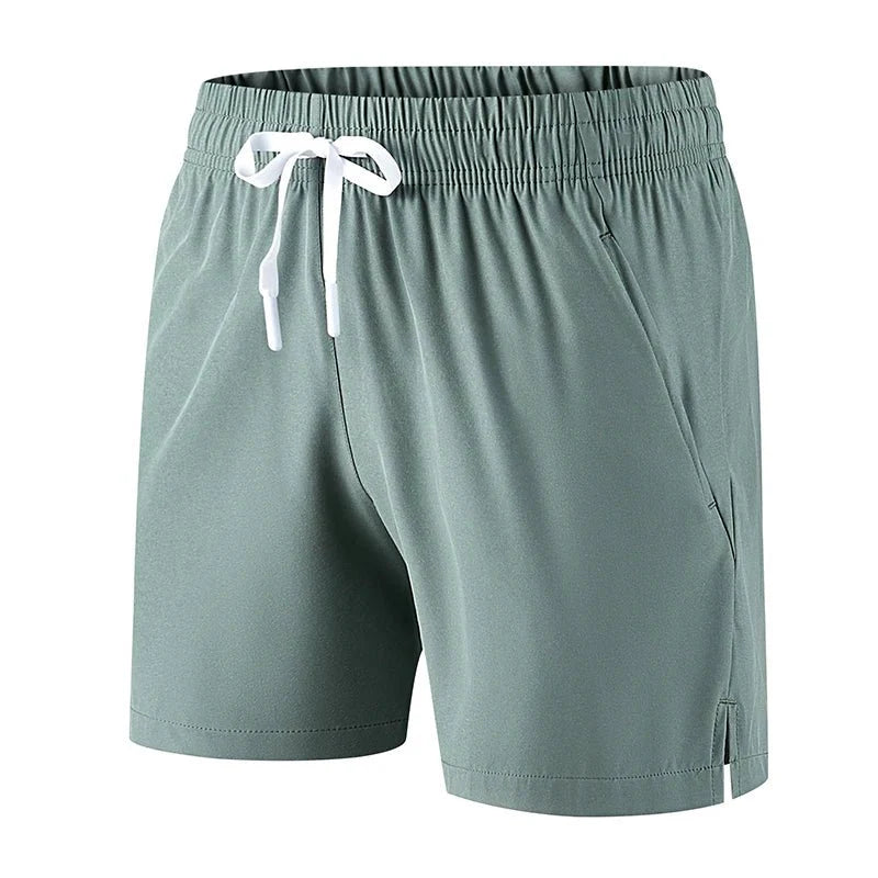 Front view of light green running shorts featuring an elastic waistband.