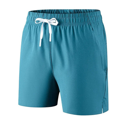 Detail view of lightweight teal running shorts with drawstring.