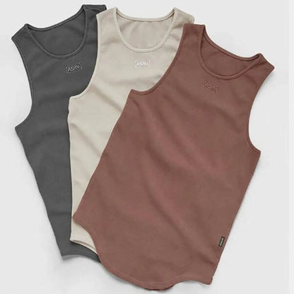 Lifestyle shot of three tank tops in black, beige, and brown showcasing sleeveless style.
