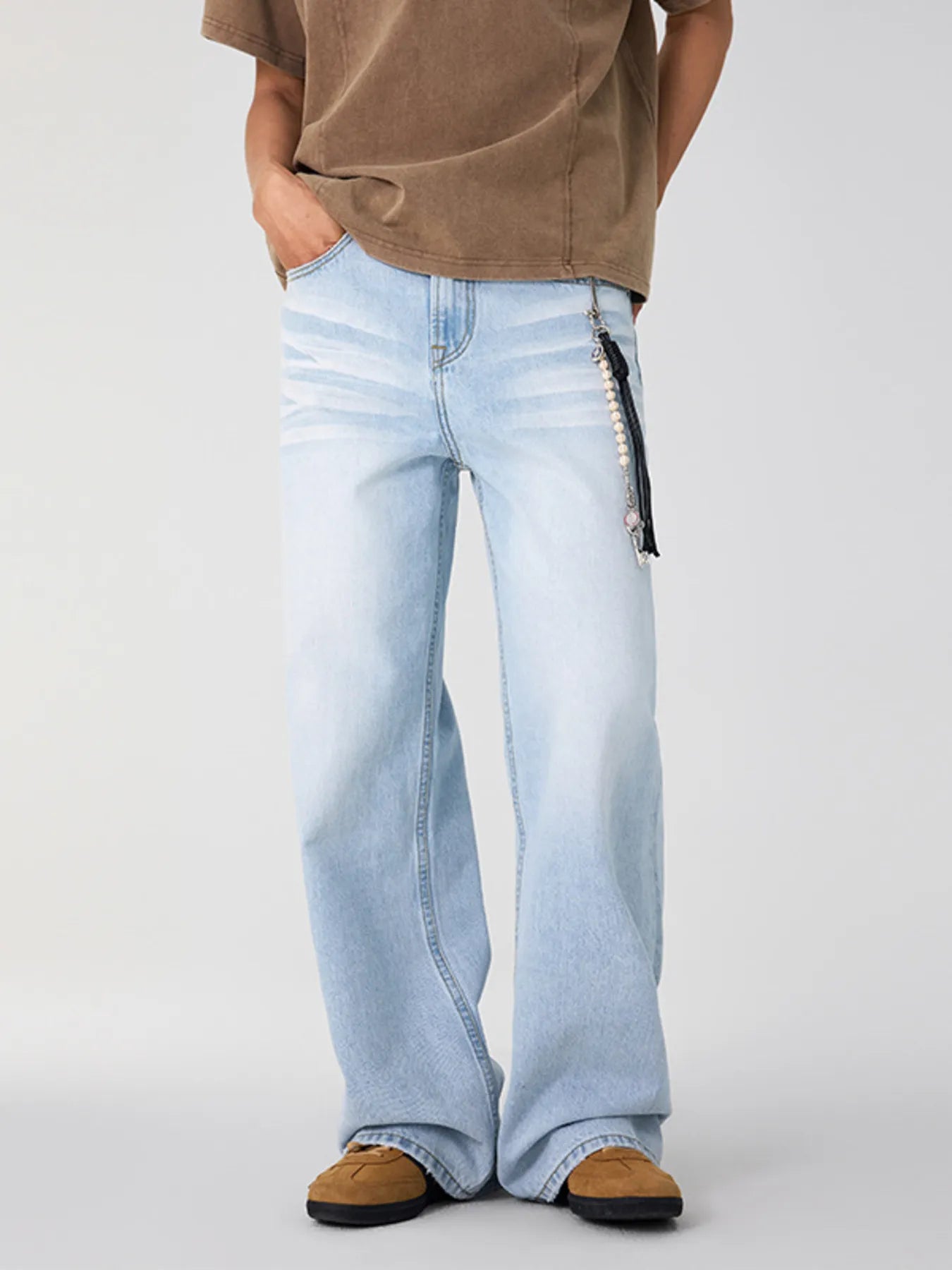Light blue wide leg jeans in a lifestyle setting with a faded wash.