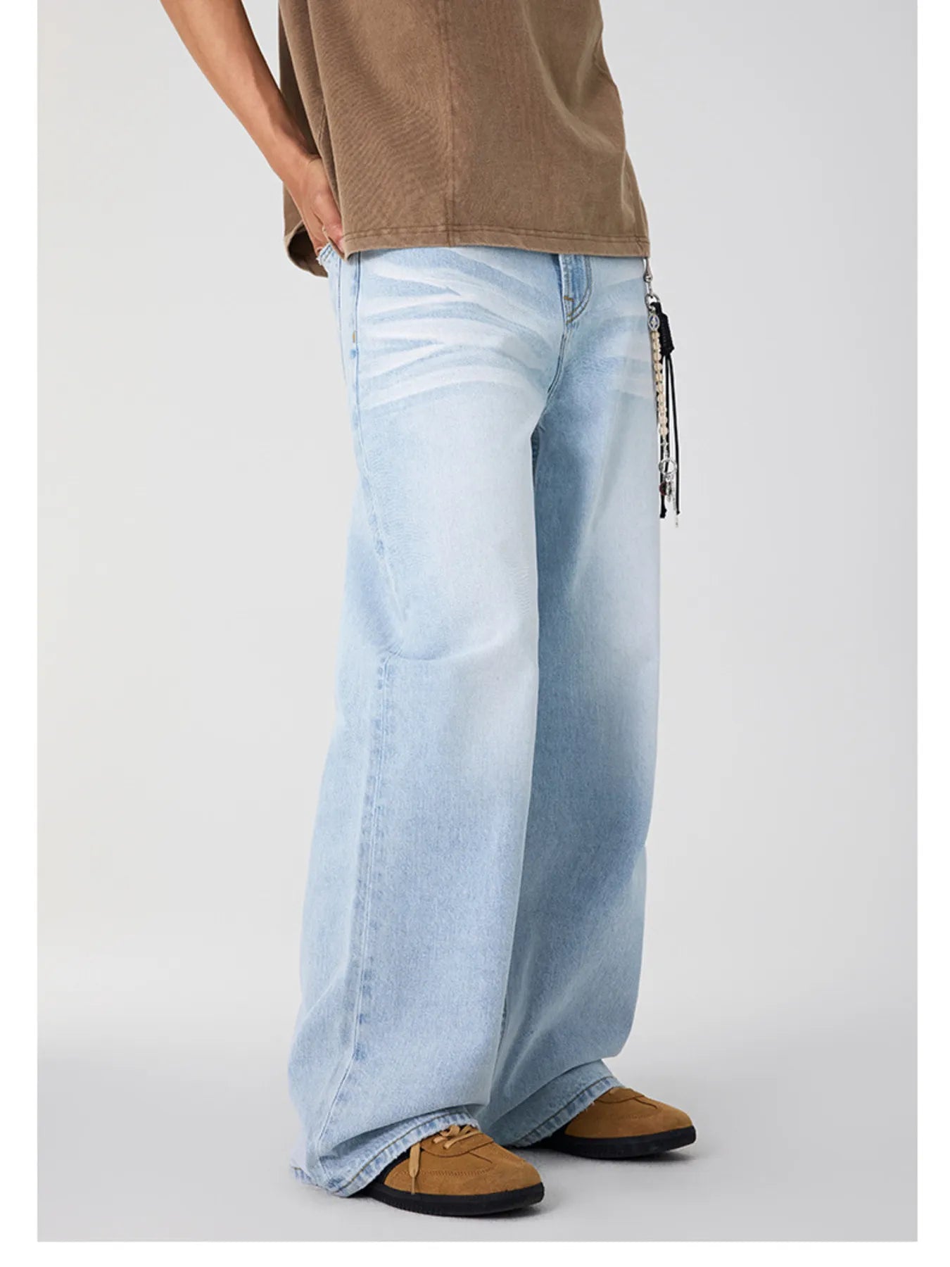 Side view of light blue wide leg jeans featuring a faded wash.