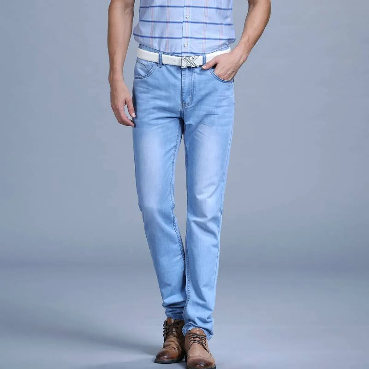 Front view of light blue slim jeans featuring a plain design.