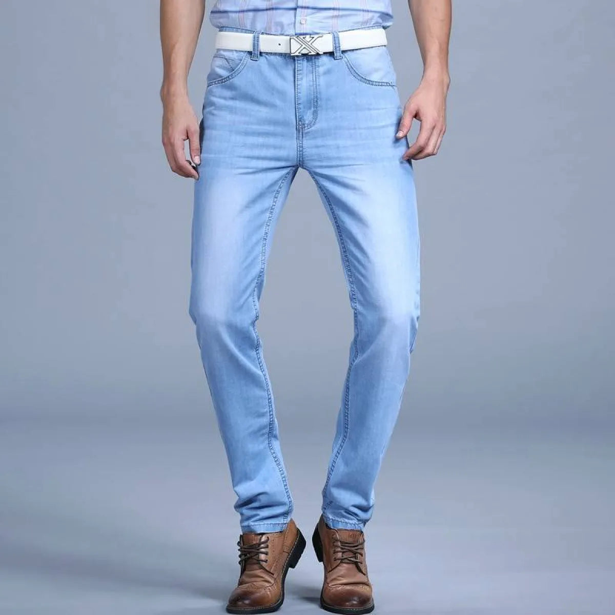 Front view of blue slim jeans featuring washed denim.
