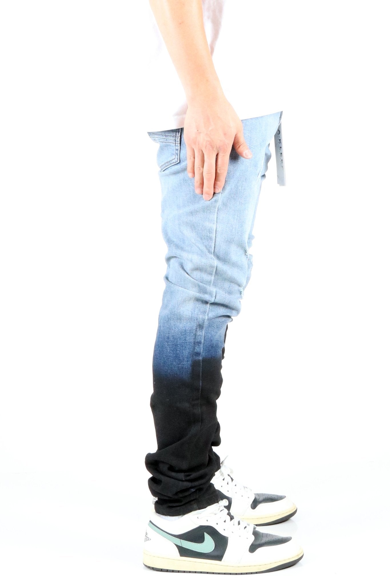 Back view of the heavy washed skinny denim pants with a focus on the ombre effect.