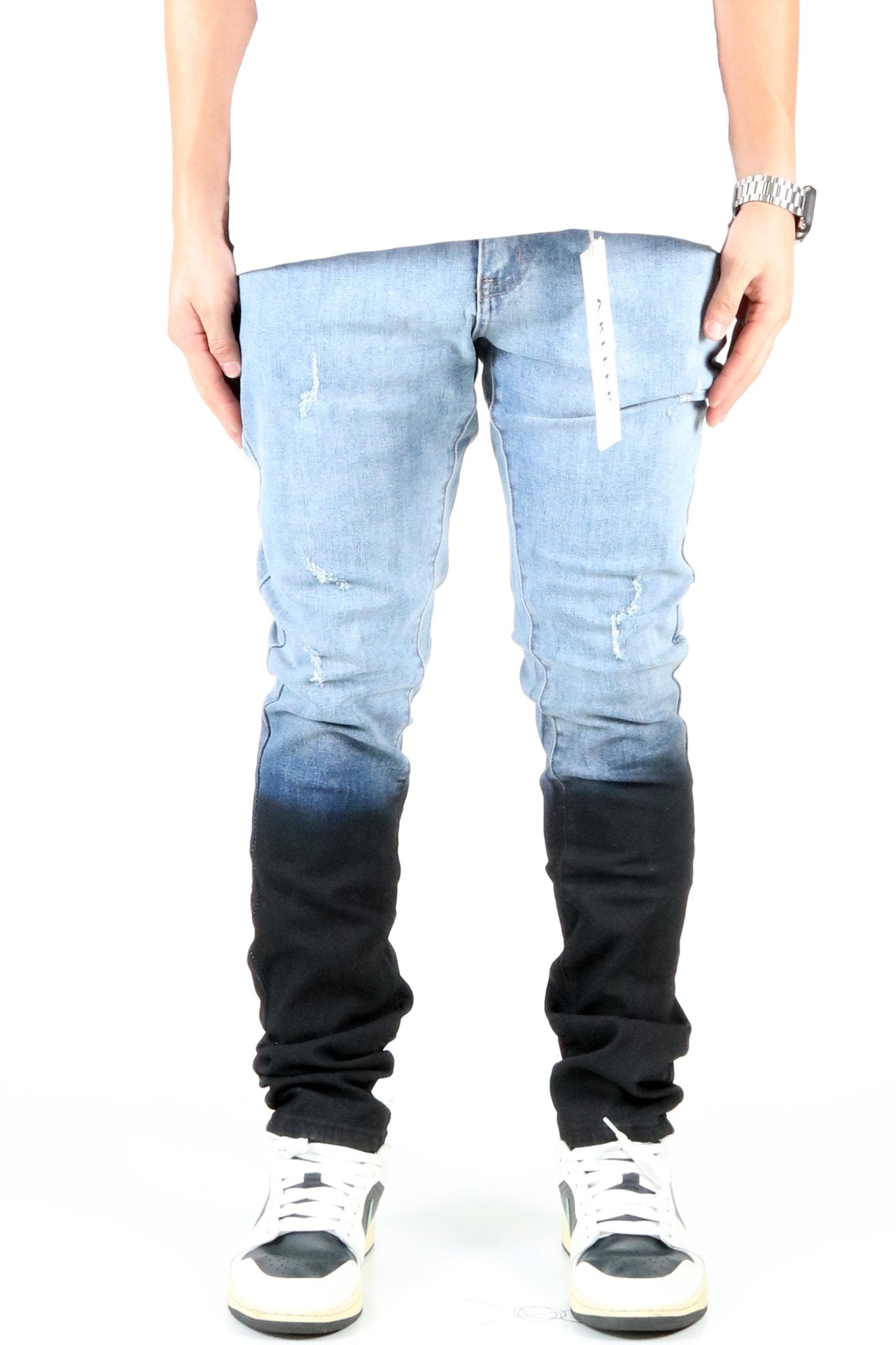 Front view of the heavy washed skinny denim pants with black dip dye effect.
