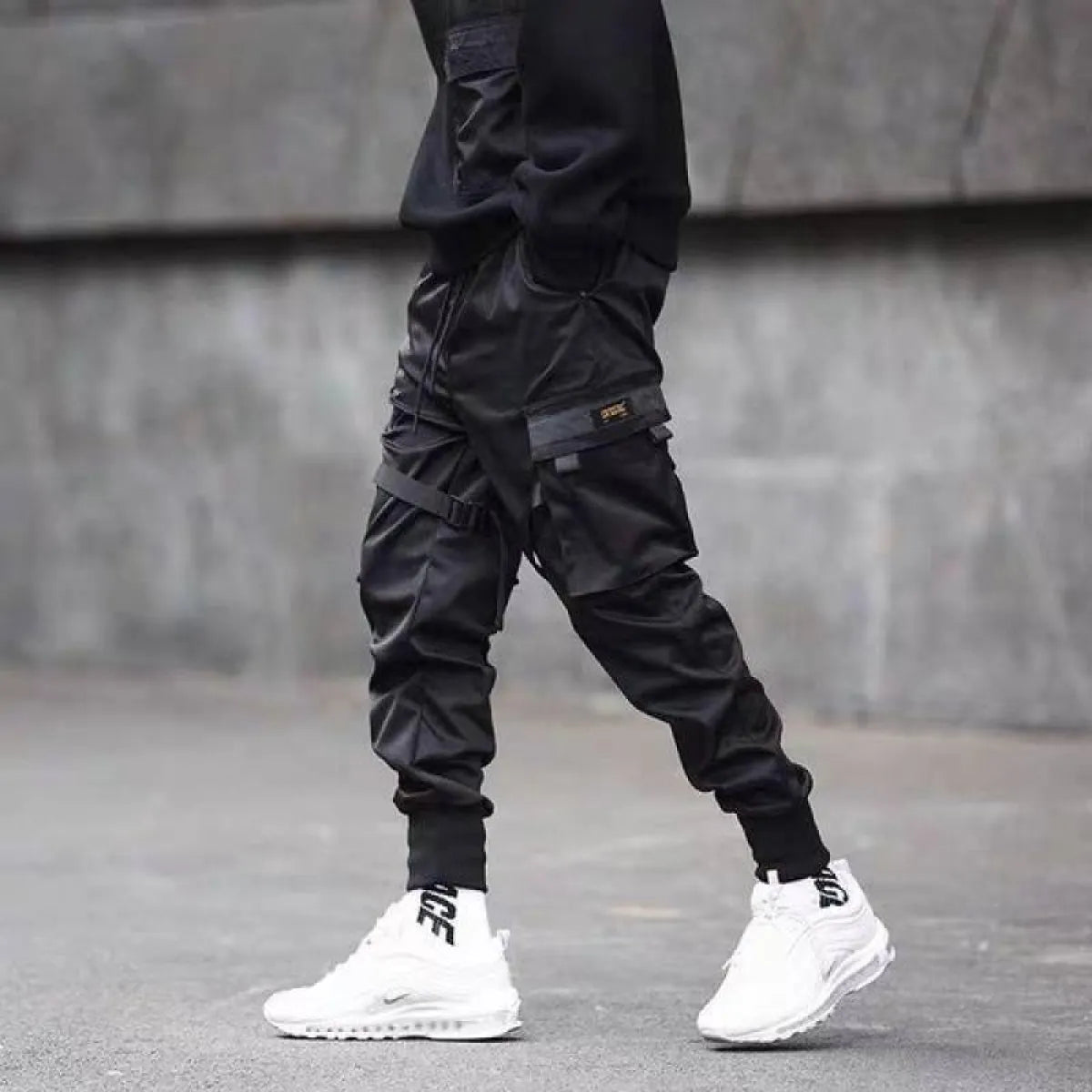 Black cargo pants with cargo pockets, lifestyle shot.