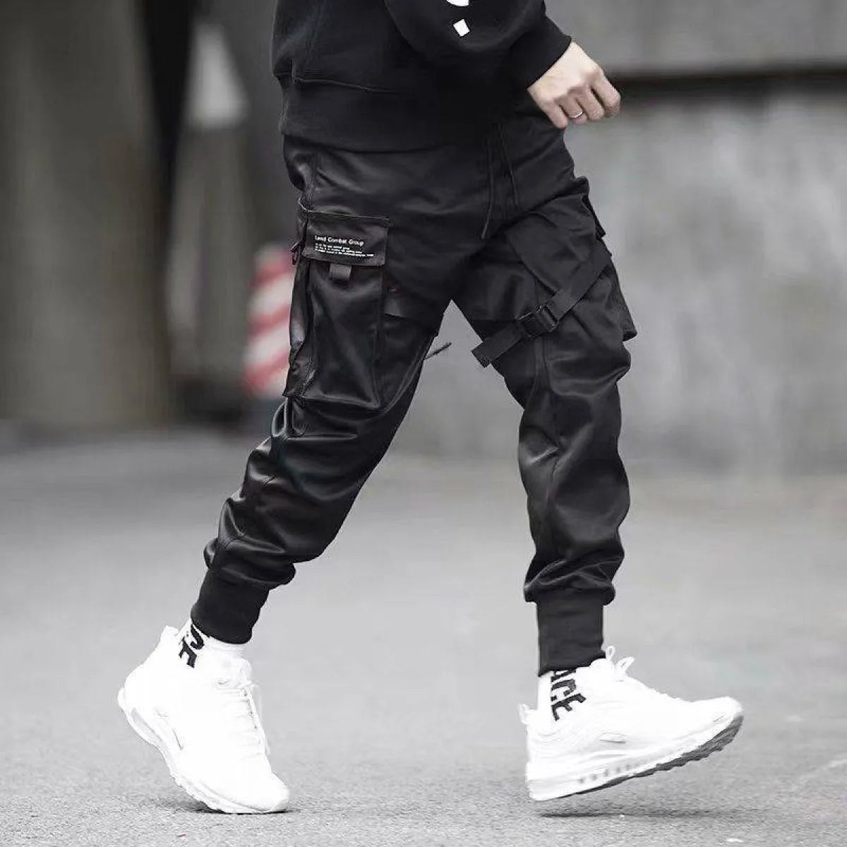 Black cargo pants showcasing cargo pockets, lifestyle shot.