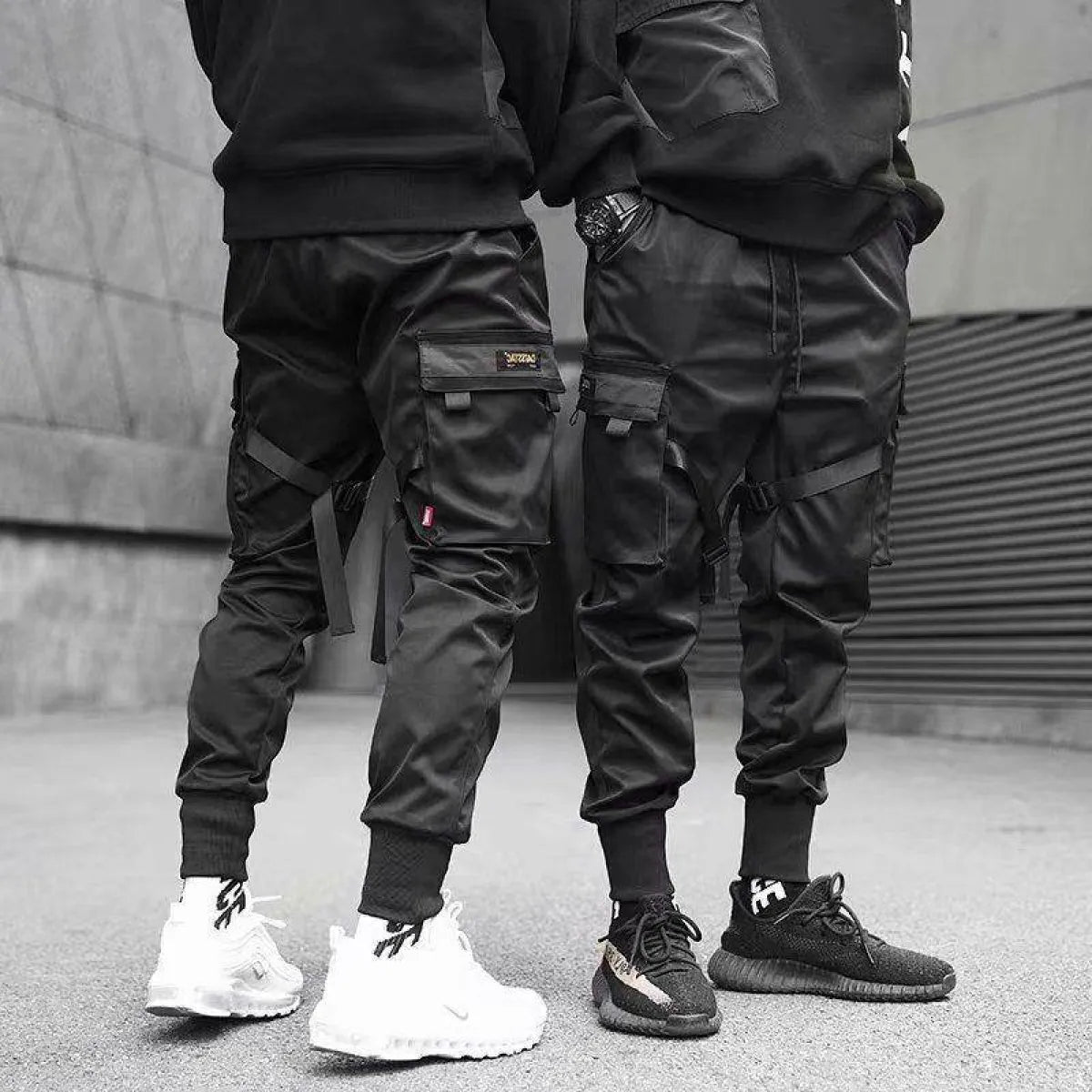 Black cargo pants featuring cargo pockets, lifestyle shot.