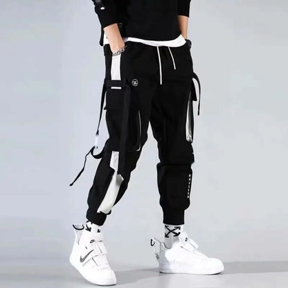 Black cargo pants with straps and elastic cuffs, front view.
