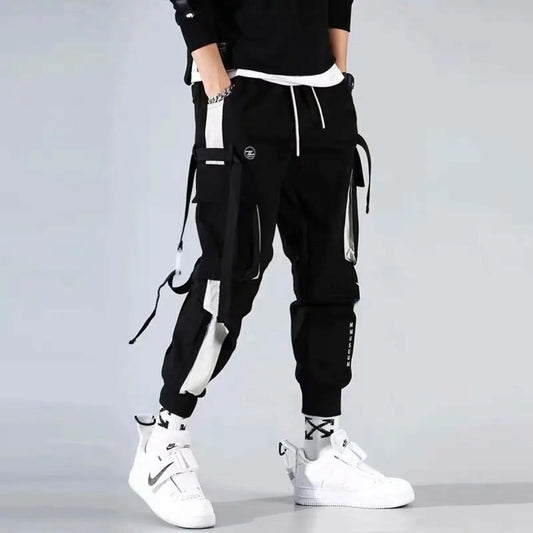 Black cargo pants with straps and elastic cuffs, front view.