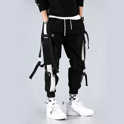 Black cargo pants featuring cargo pockets and straps, side view.