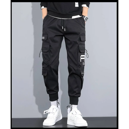 Front view of black cargo pants with cargo pockets and elastic cuffs.