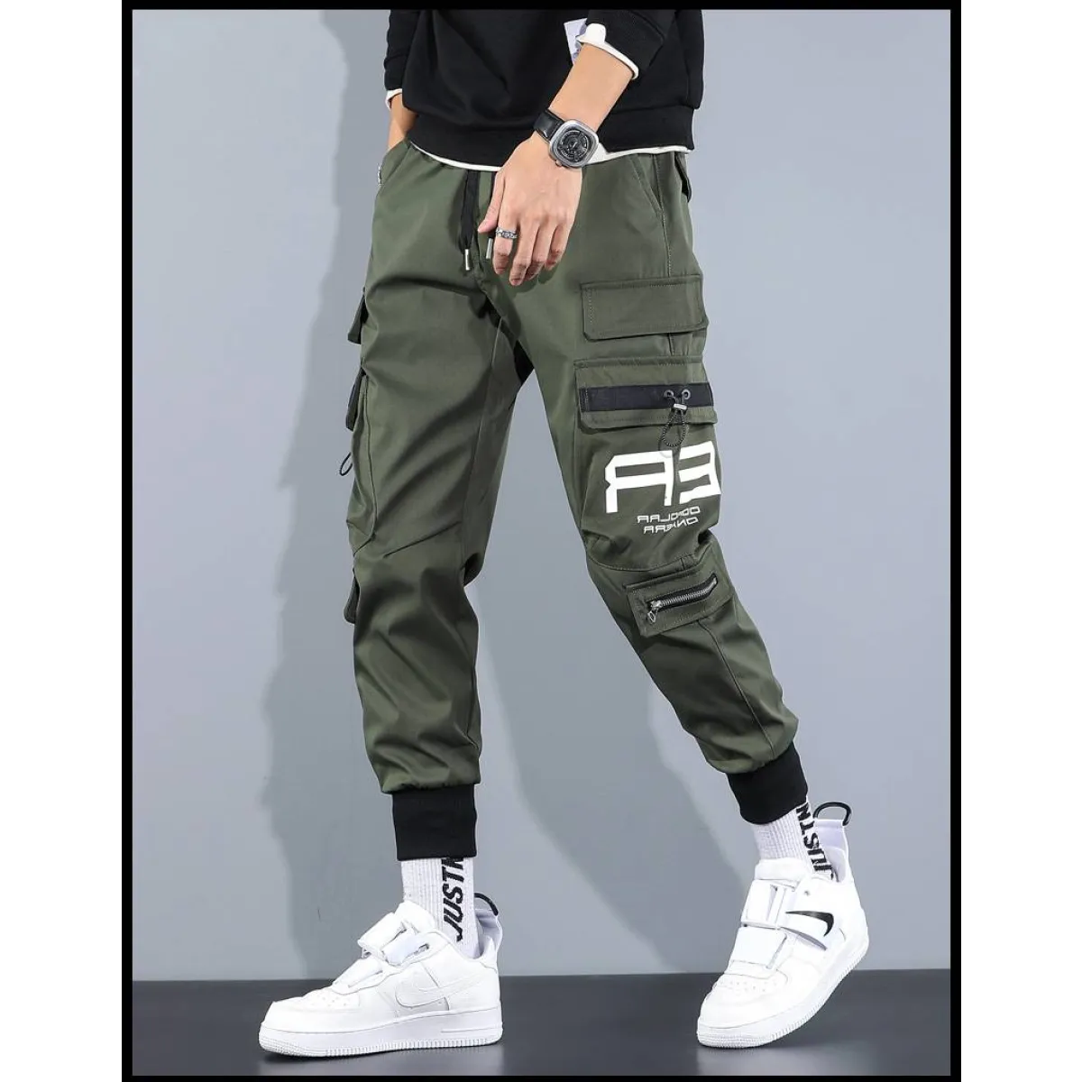 Side view of black cargo pants showcasing cargo pockets and elastic cuffs.