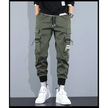 Front view of green cargo pants with cargo pockets and elastic cuffs.