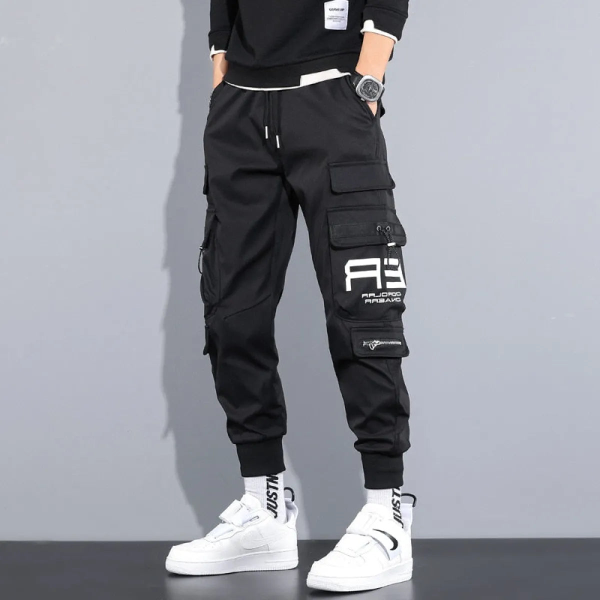 Military Techwear Pants side view featuring a graphic patch and elastic cuffs.