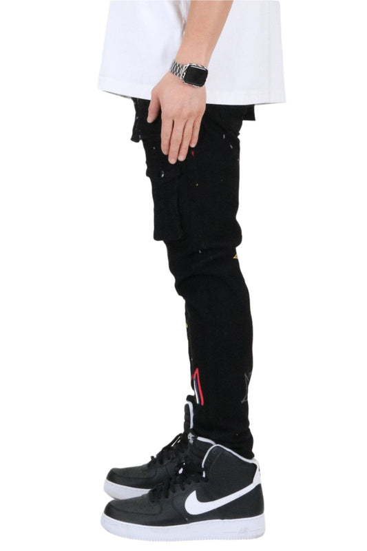 Side view of the black skinny cargo pants with graphic patches.